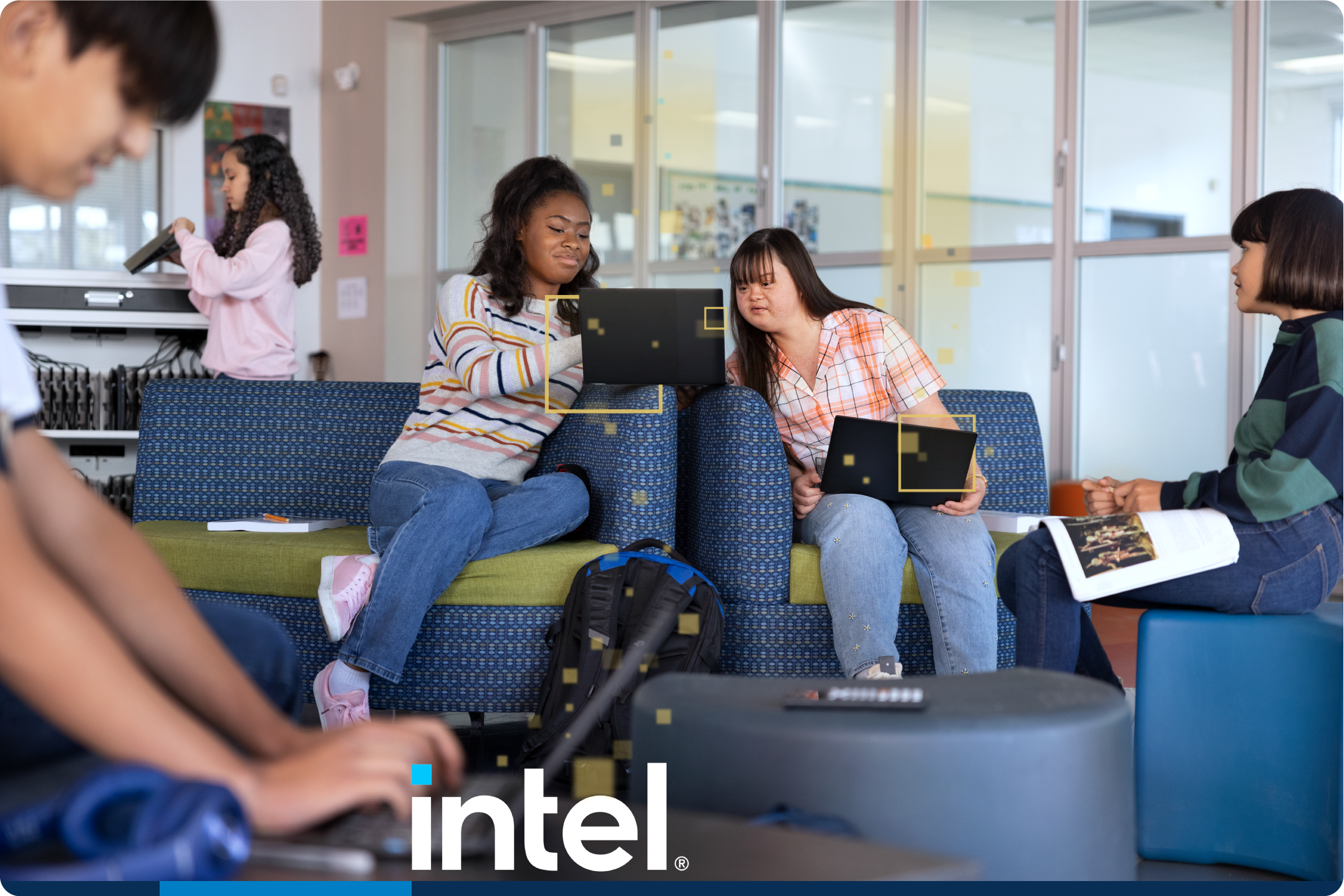 Image showing several students interacting with laptops and the Intel logo.